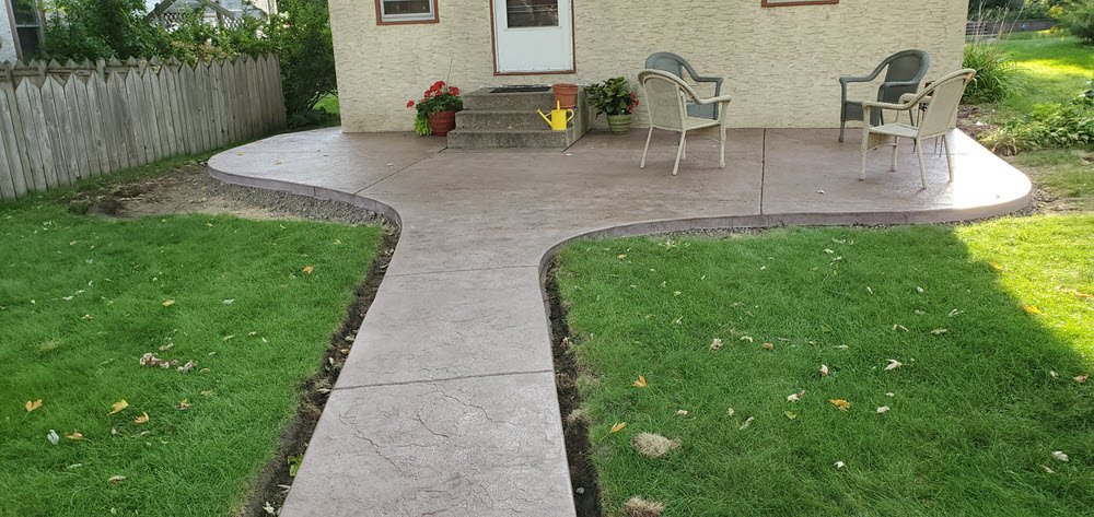 Belgium slate stamped concrete walkway and patio example | Golden Stain