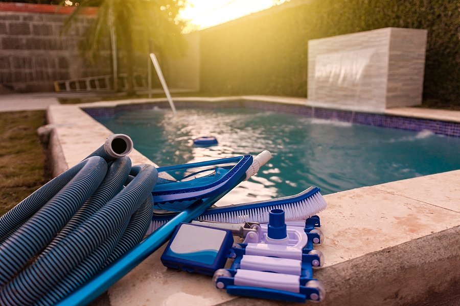 Pool cleaning and maintenance kit, Cleaning and maintenance tools on the edge of the pool. vacuum