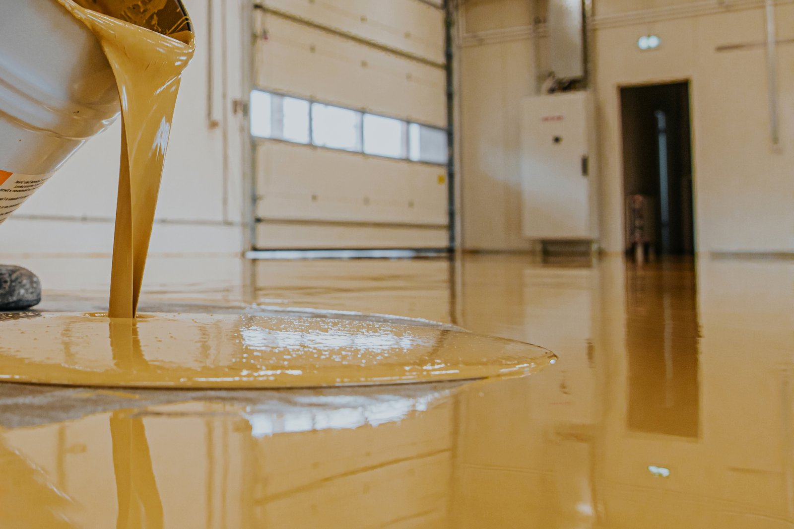 Worker coating floor with self leveling epoxy res 2023 11 27 05 12 29 utc scaled
