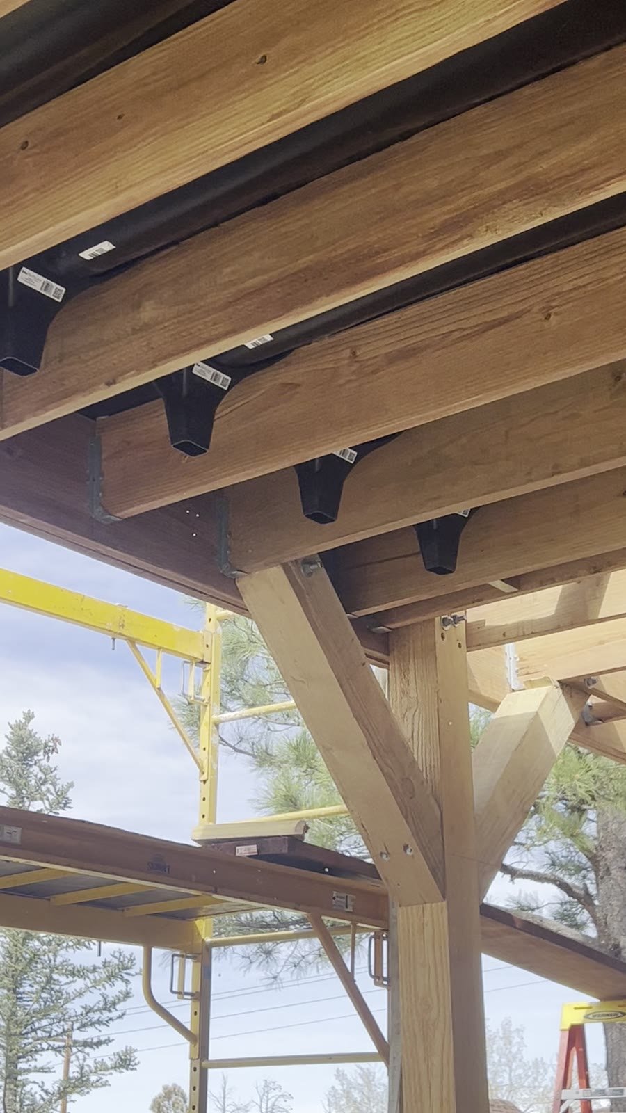 New deck framing with cedar posts, knee braces, joists and under-deck drainage troughs