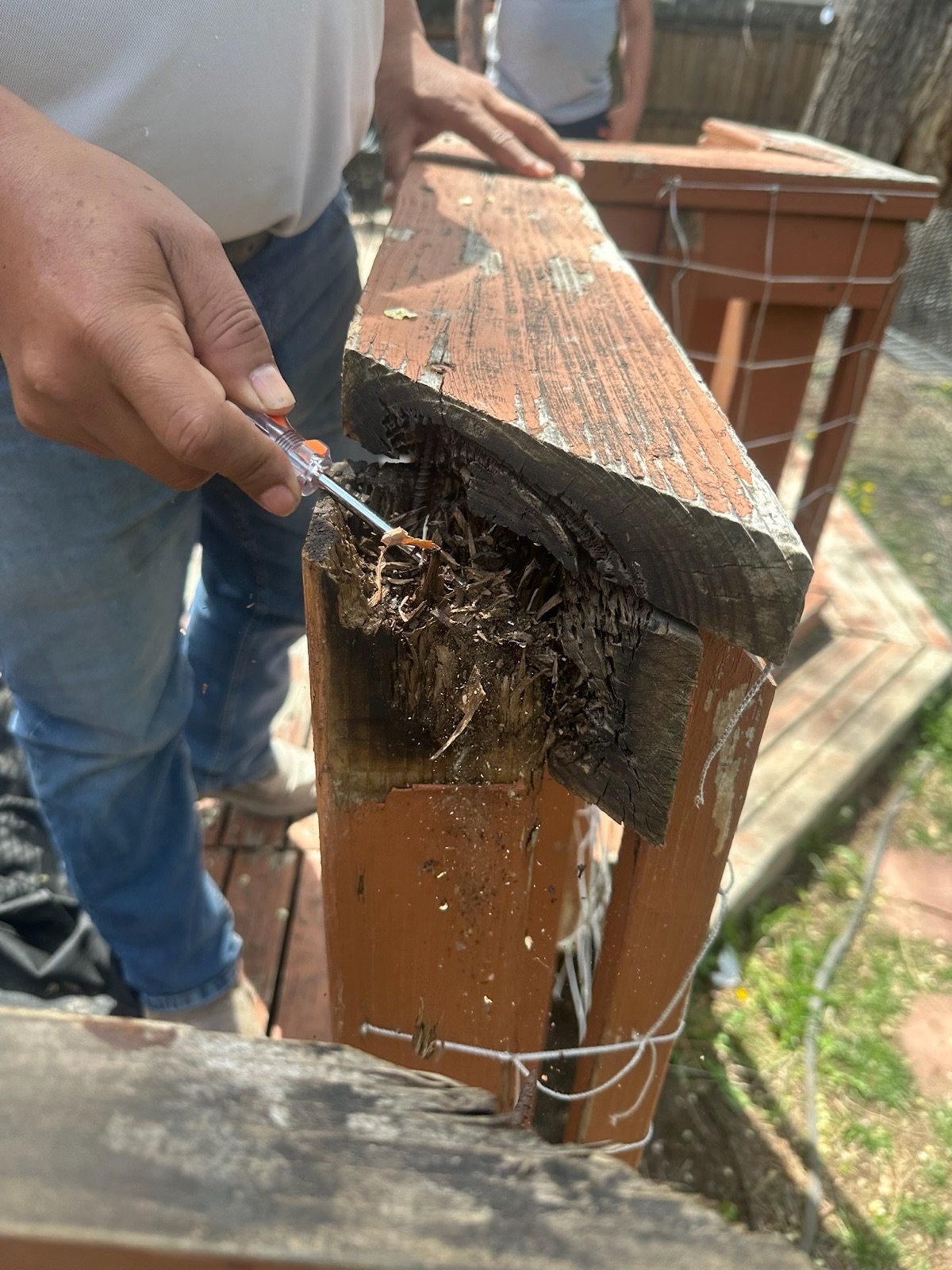 A rotted fence post top showing why posts fail at the ground line