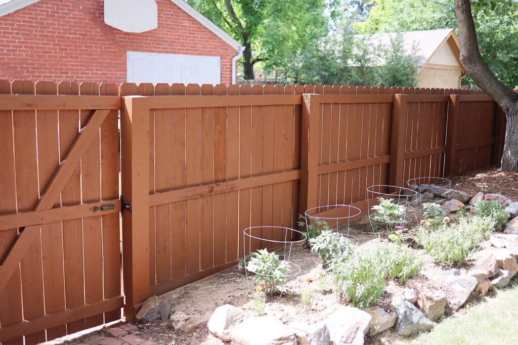stained fence rock garden 1